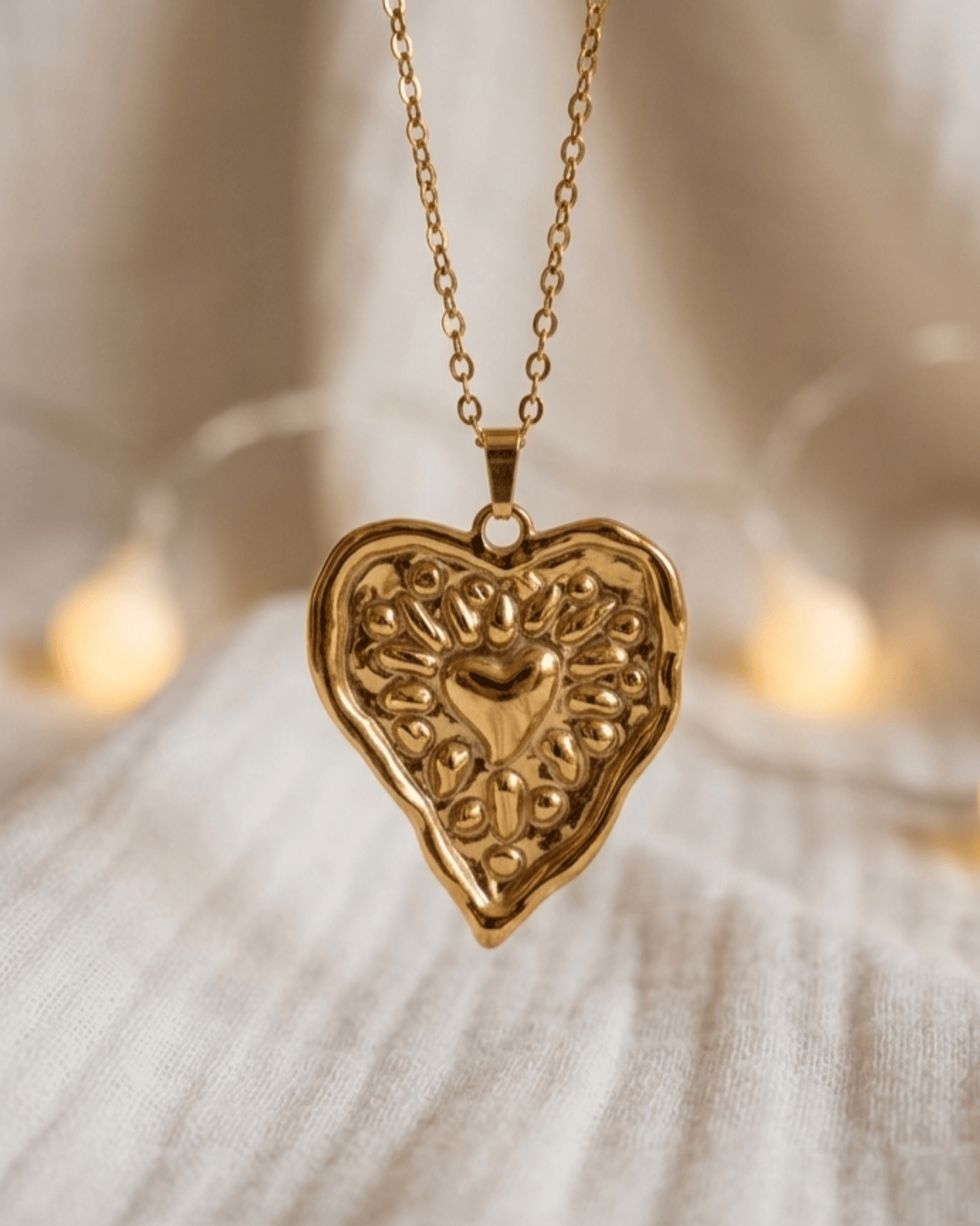 Collana Mary Giunquilla in oro 18k con cuore sacro, simbolo di cura e devozione materna Ciondolo Giunquilla con cuore sacro dorato, archetipo della forza materna cosmica Collana pendente Giunquilla con cuore sacro in acciaio placcato oro 18k, memoria ancestrale e armonia Ciondolo Mary Giunquilla, oro 18k: indossare la protezione del femminile materno e divino Collana Giunquilla con cuore sacro, gioiello spirituale per donne legate al sacro femminile
